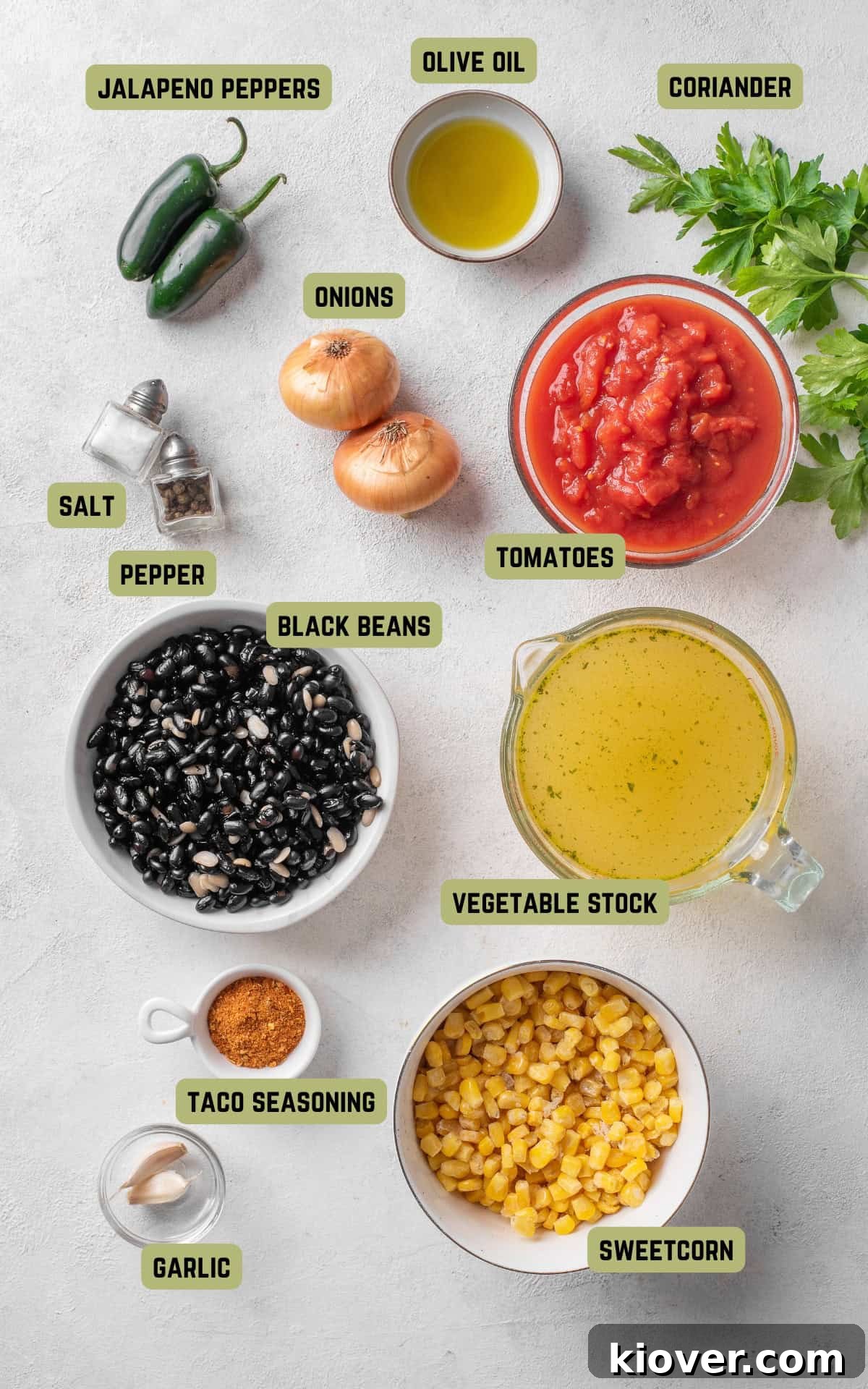 Vibrant Fiesta Soup 3 Fresh ingredients laid out for making Mexican Soup: olive oil, onions, garlic, jalapenos, seasonings, canned tomatoes, black beans, sweetcorn, and vegetable stock.