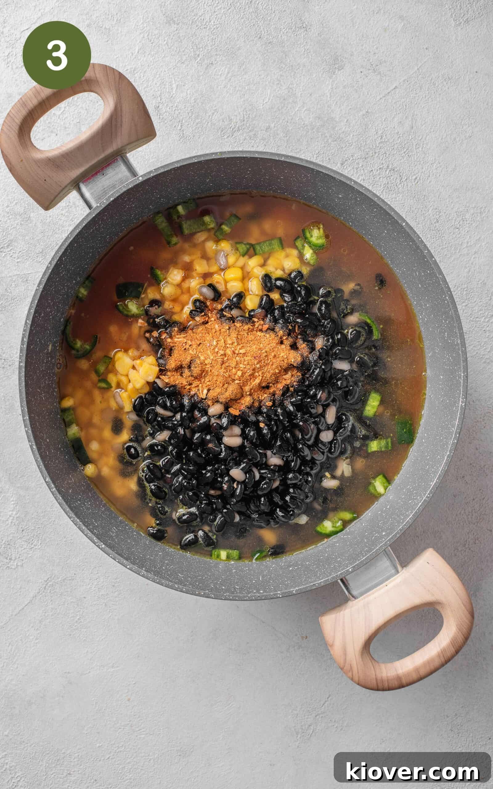 Vibrant Fiesta Soup 6 Adding taco seasoning, a can of chopped tomatoes, black beans, and corn to the pot with sautéed vegetables.