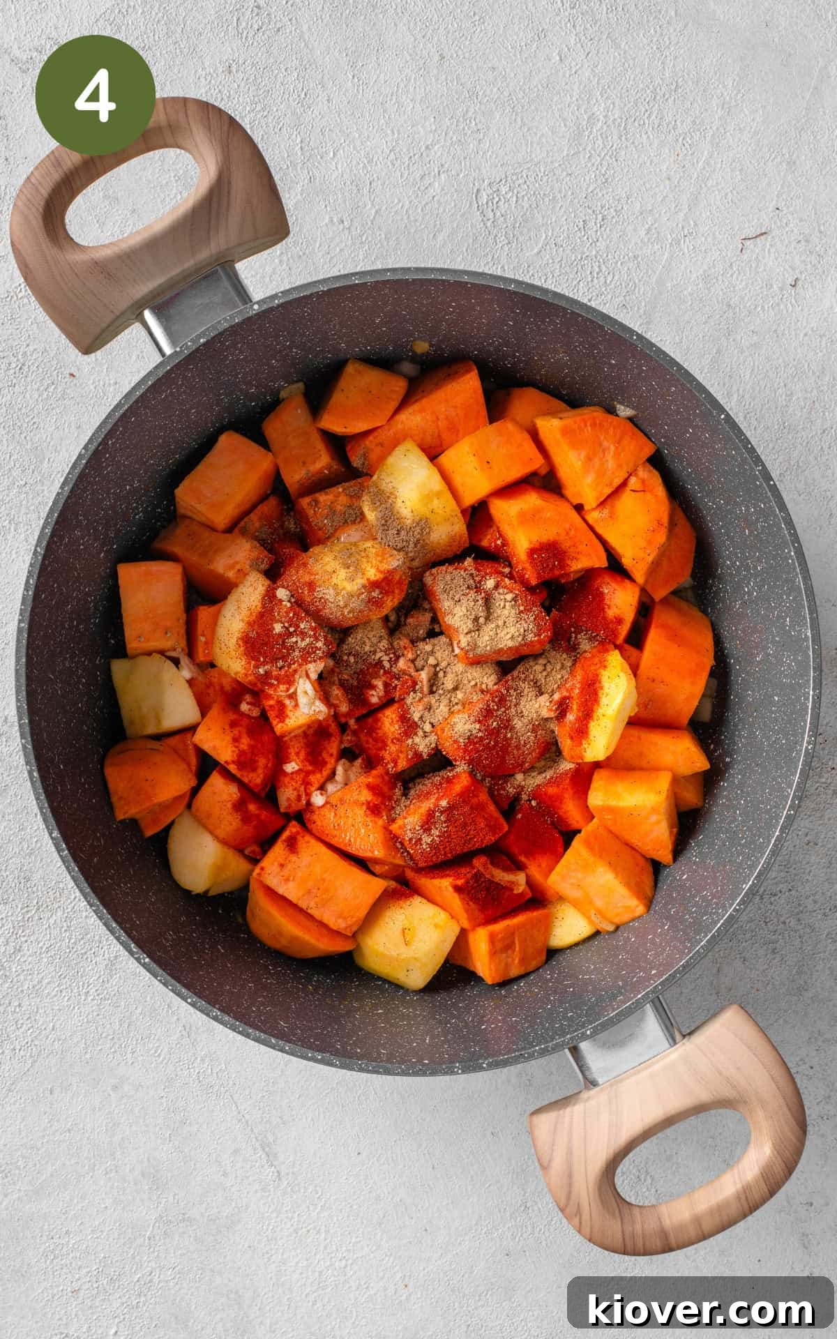 Spiced Sweet Potato Warmth 7 Garlic and various spices being added to the simmering sweet potatoes and apples in the sauce pot.