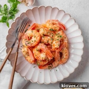 Garlic prawns served on a plate, garnished with parsley.