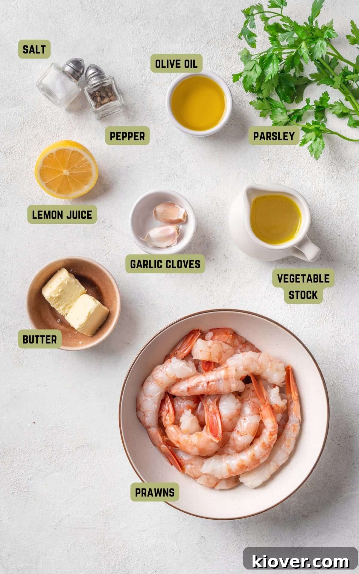 Ingredients for making Garlic Prawns, including fresh prawns, garlic, lemon, butter, and parsley.