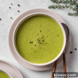 Courgette soup served in a plate with a garnish.
