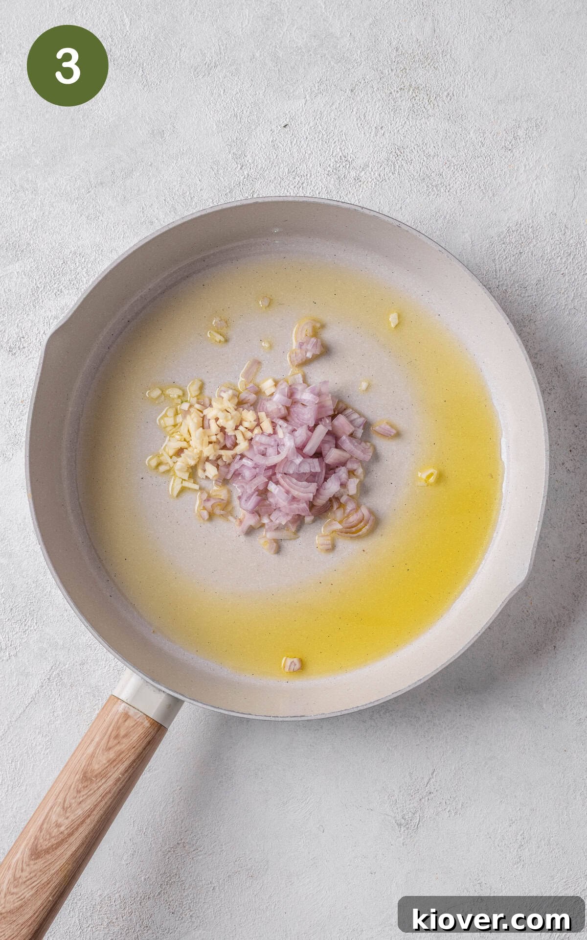 Finely chopped shallots and minced garlic sizzling in olive oil in a skillet over medium-high heat.