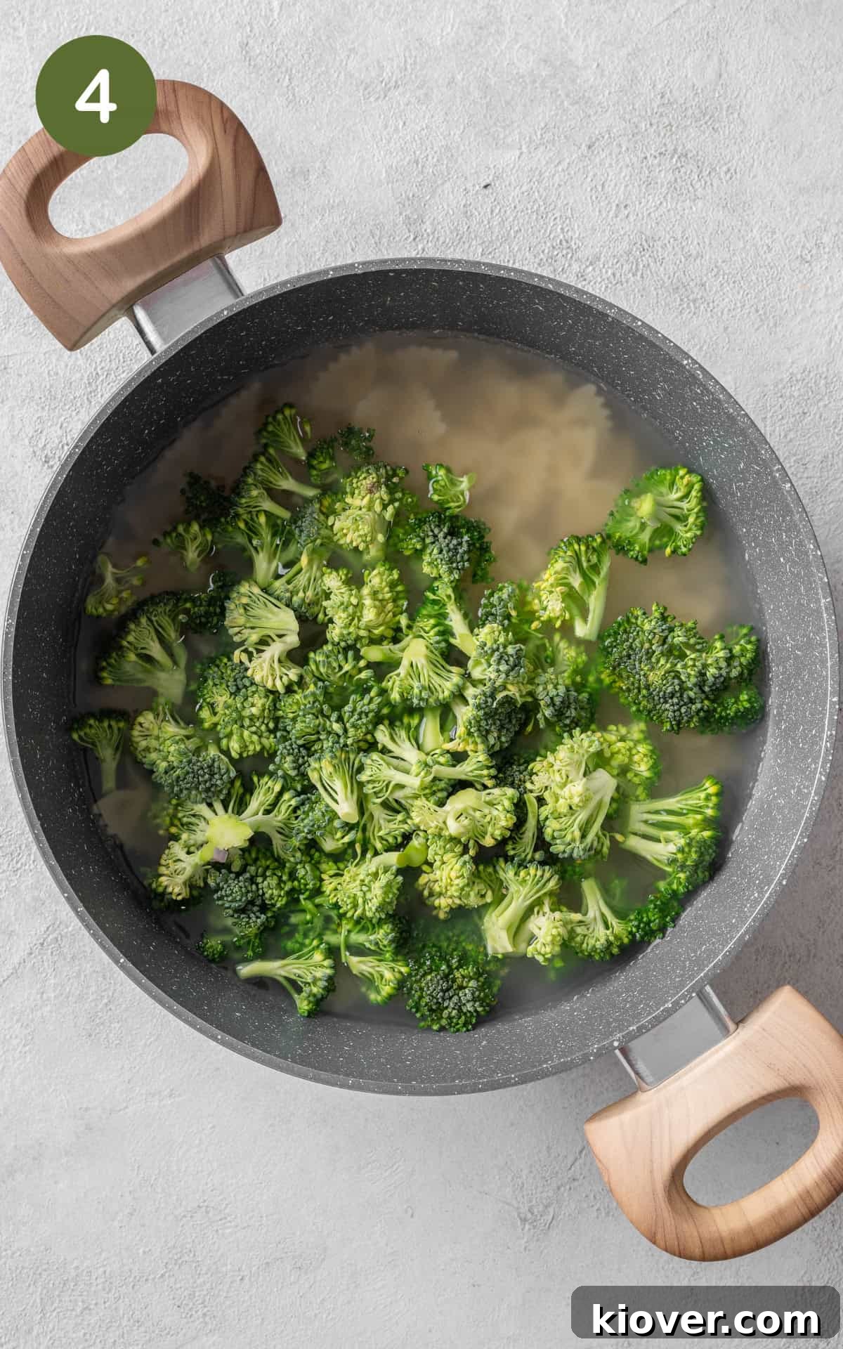 Broccoli florets added to the pot with cooking pasta for the final minutes of boiling.
