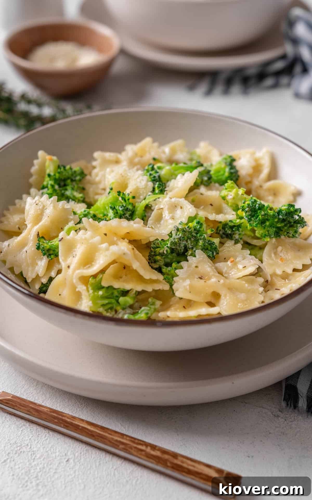 A generous serving of creamy broccoli pasta in a shallow bowl, ready to be enjoyed.
