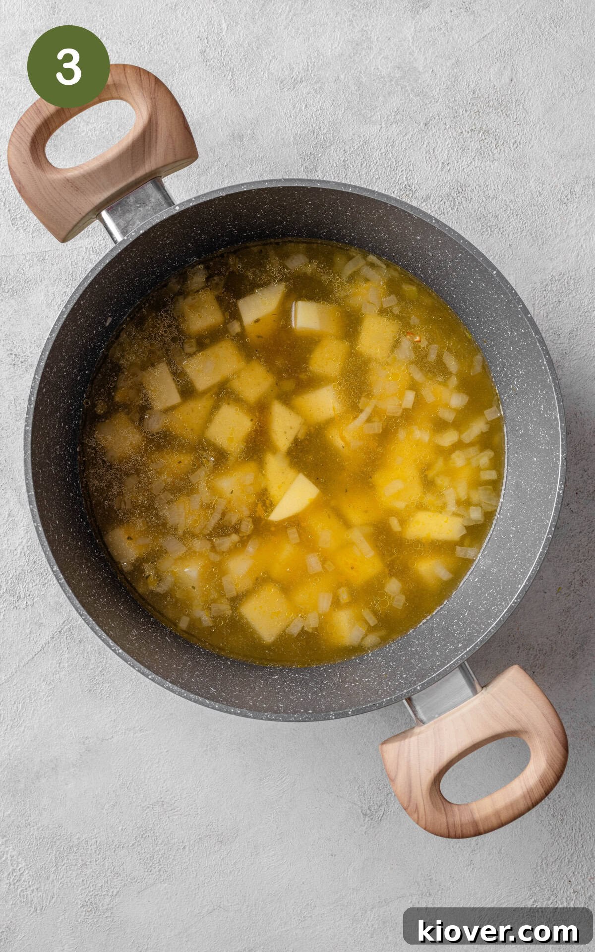Velvety Spinach Soup 6 Cubed potatoes cooking in vegetable stock, simmering gently in a pot on the stove until tender.