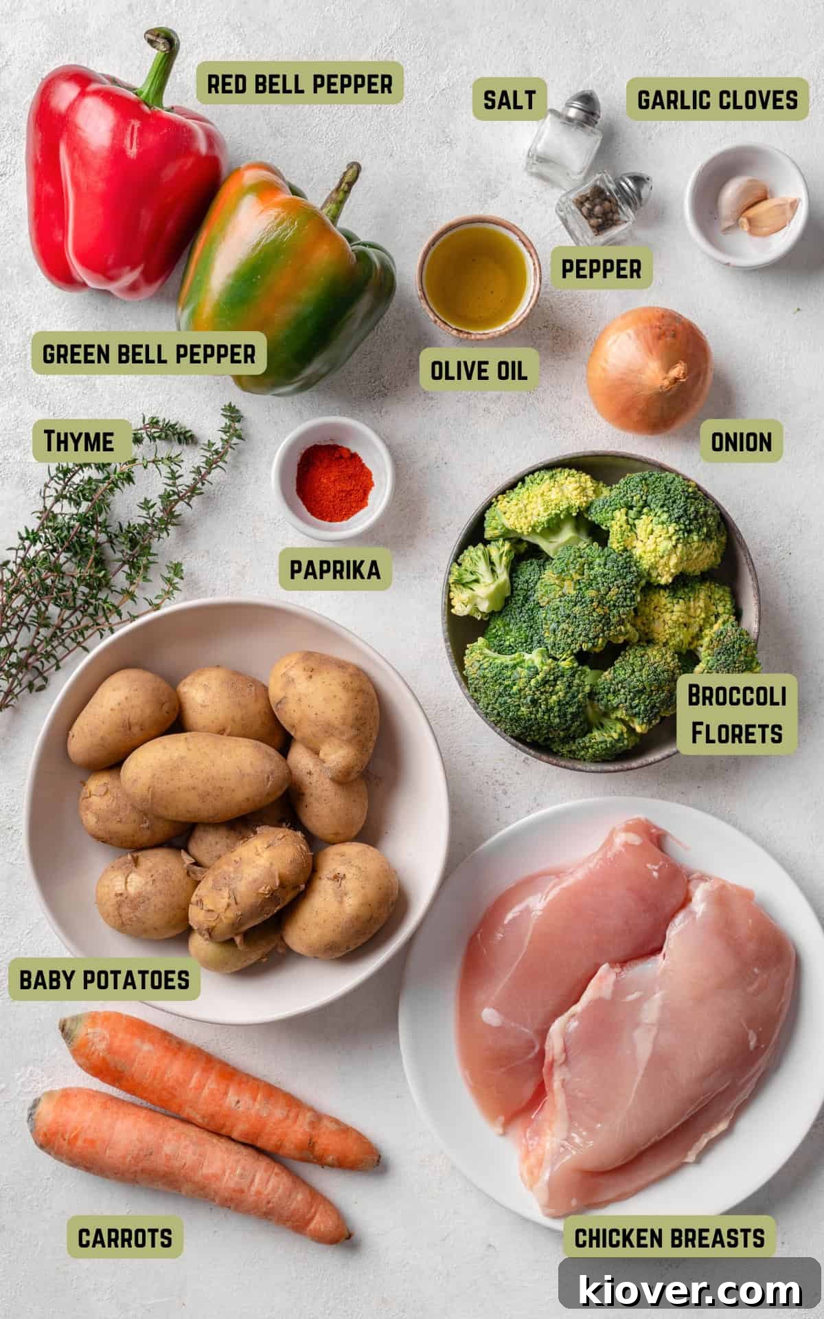 A selection of fresh, colourful ingredients laid out on a wooden surface, ready to be prepared for the chicken traybake.