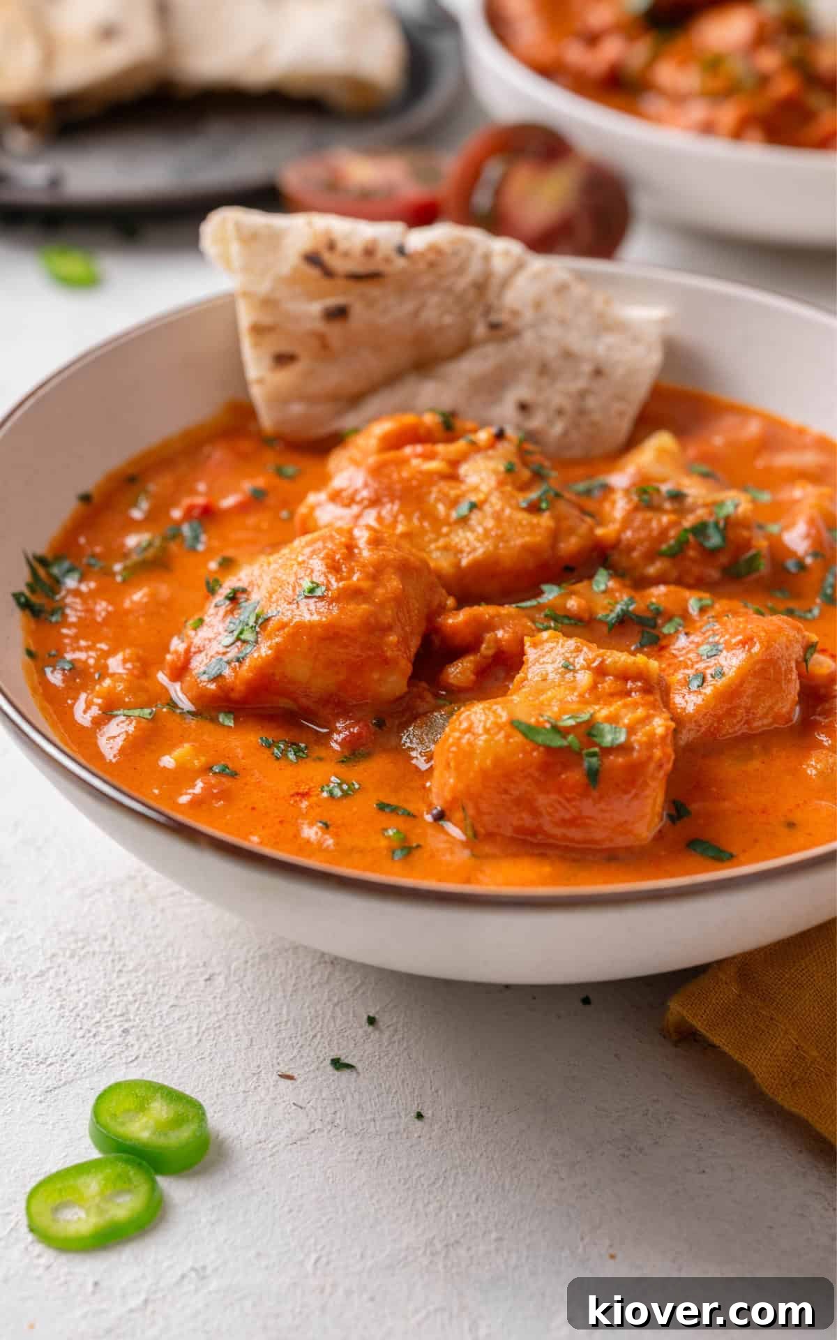 Fish curry served with pita bread.