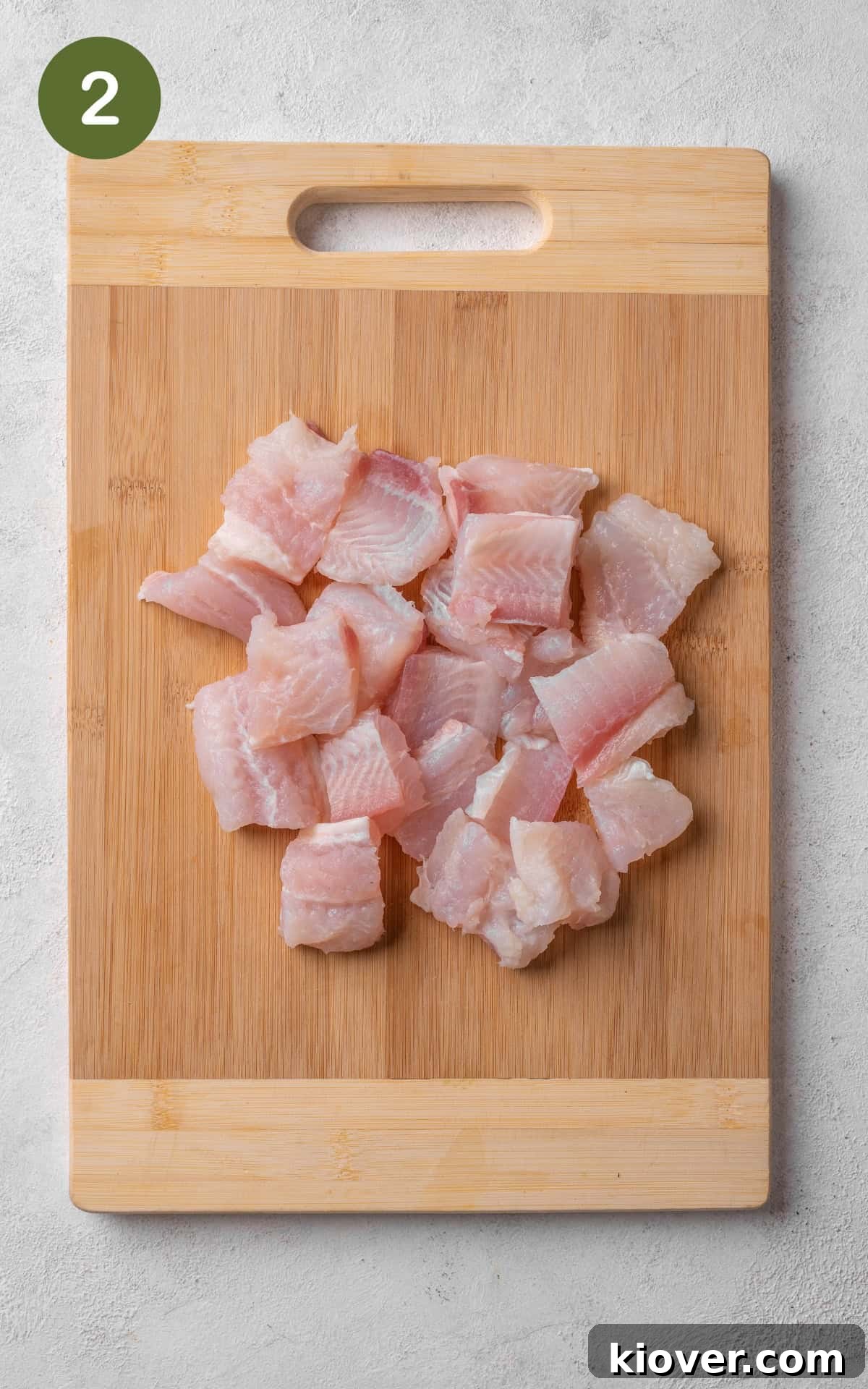 Chopped fish on a cutting board.