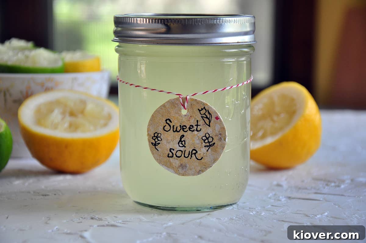 A mason jar filled with freshly made sweet and sour mix, ready for use in cocktails.