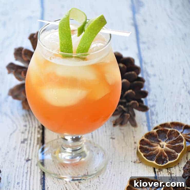 A beautifully crafted Gin and Tonic with a heart-shaped lime twist, served in an elegant glass