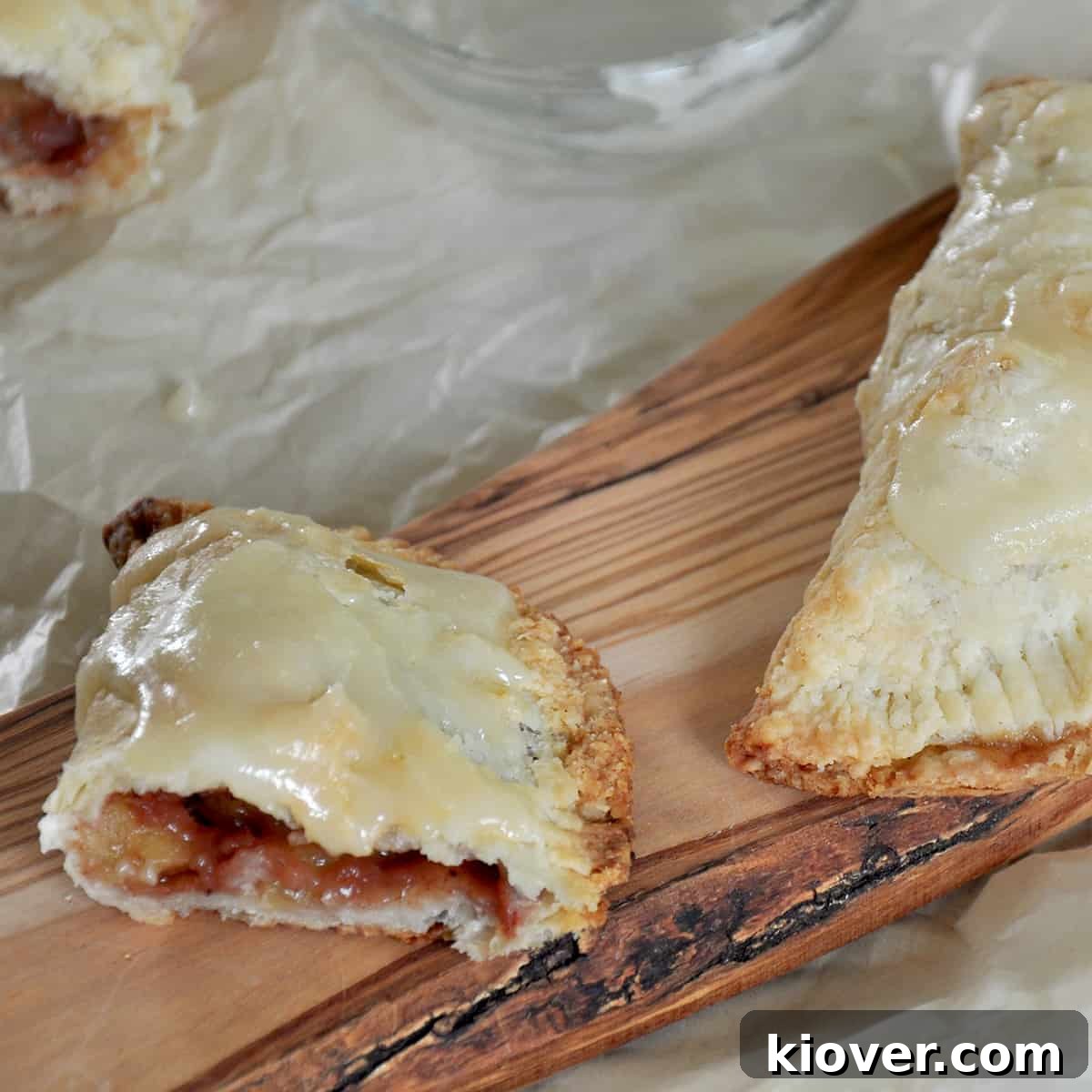 Baked and Cut Hand Pie Half of an apple hand pie on a cutting board.