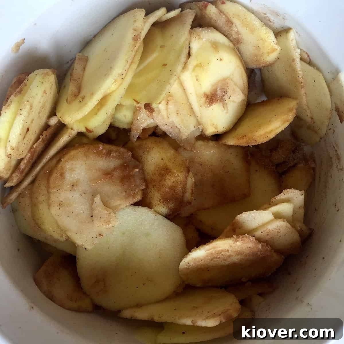Mixed Apples with flour, sugar, cinnamon, and nutmeg, showcasing the crostata filling.