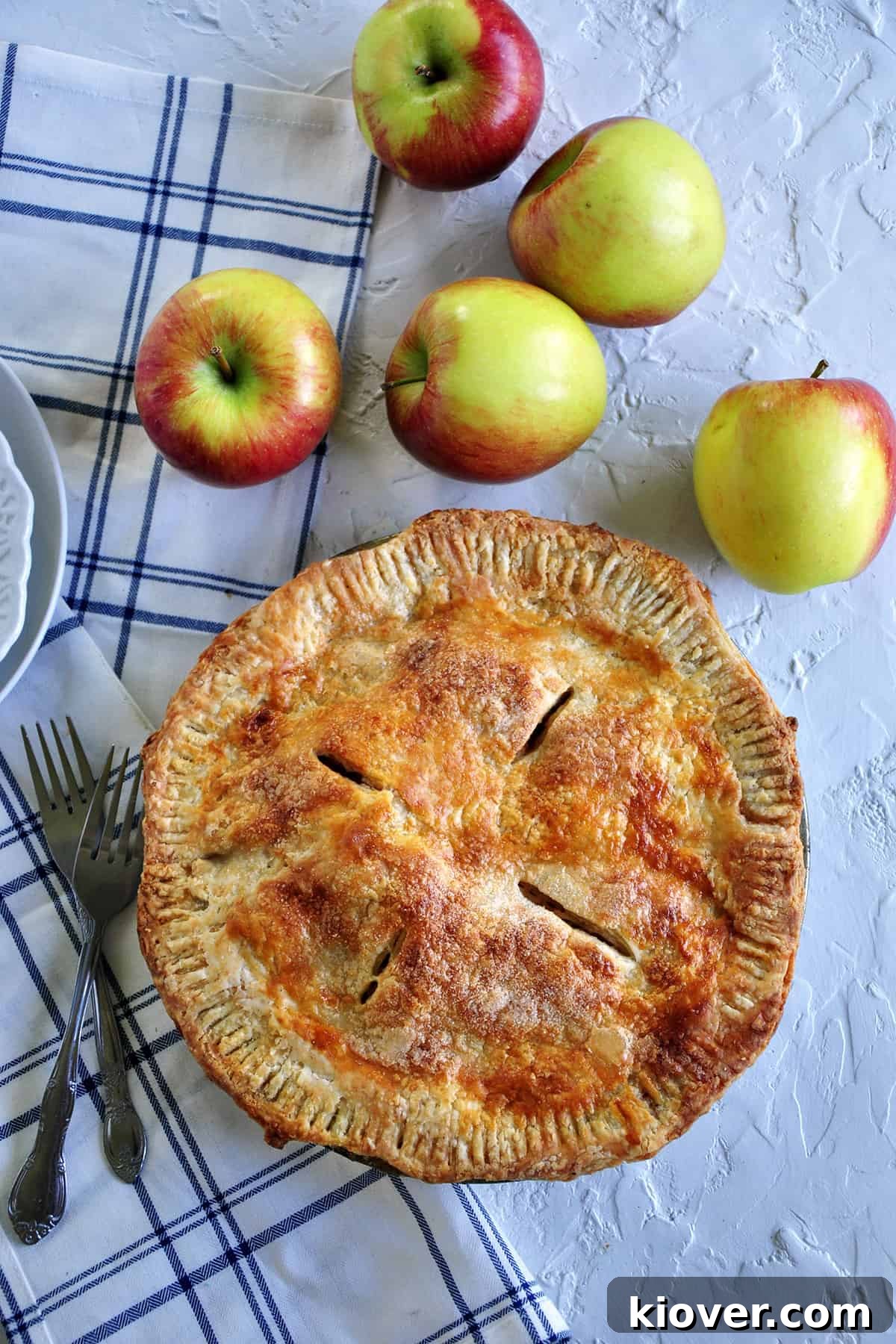 Baked Apple pie on a white table.
