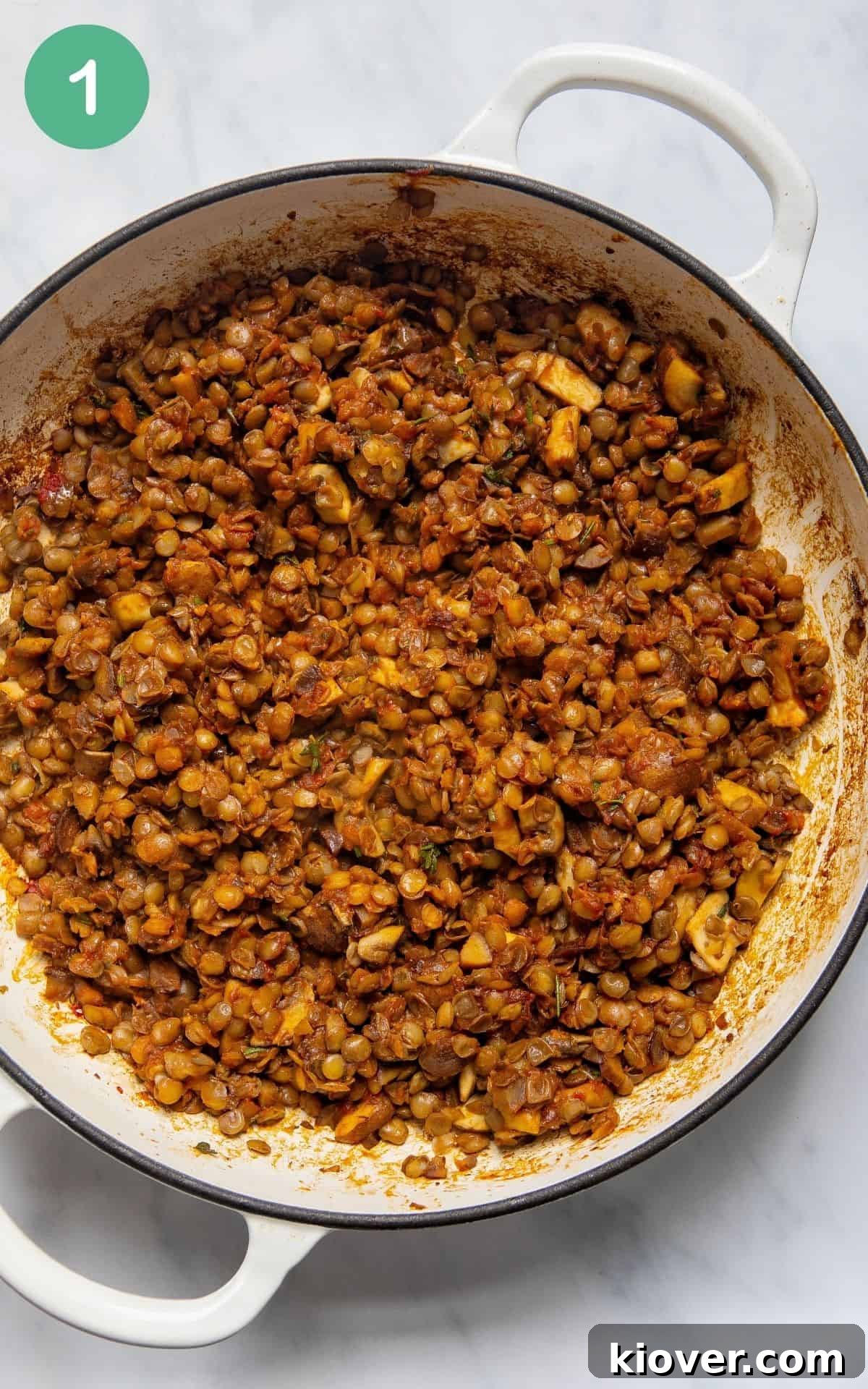 Effortless Lentil Wellington 4 a white dutch oven with all the ingredients mixed together for the lentil wellington filling