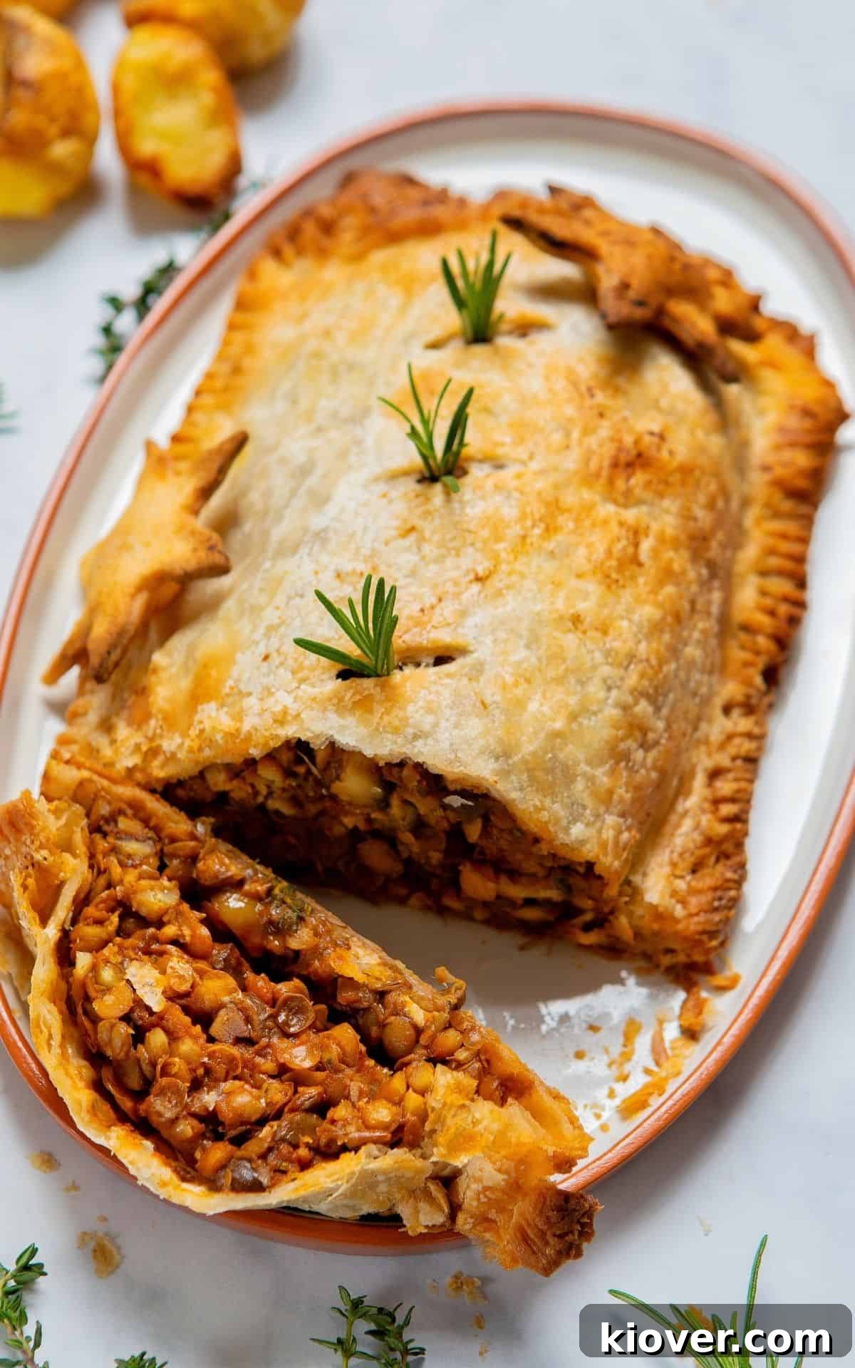 Effortless Lentil Wellington 7 mushroom wellington sliced on a serving plate, ready to be enjoyed