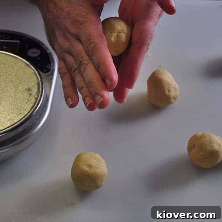 Four tortilla balls with one being rounded off in my hand for these homemade tortillas