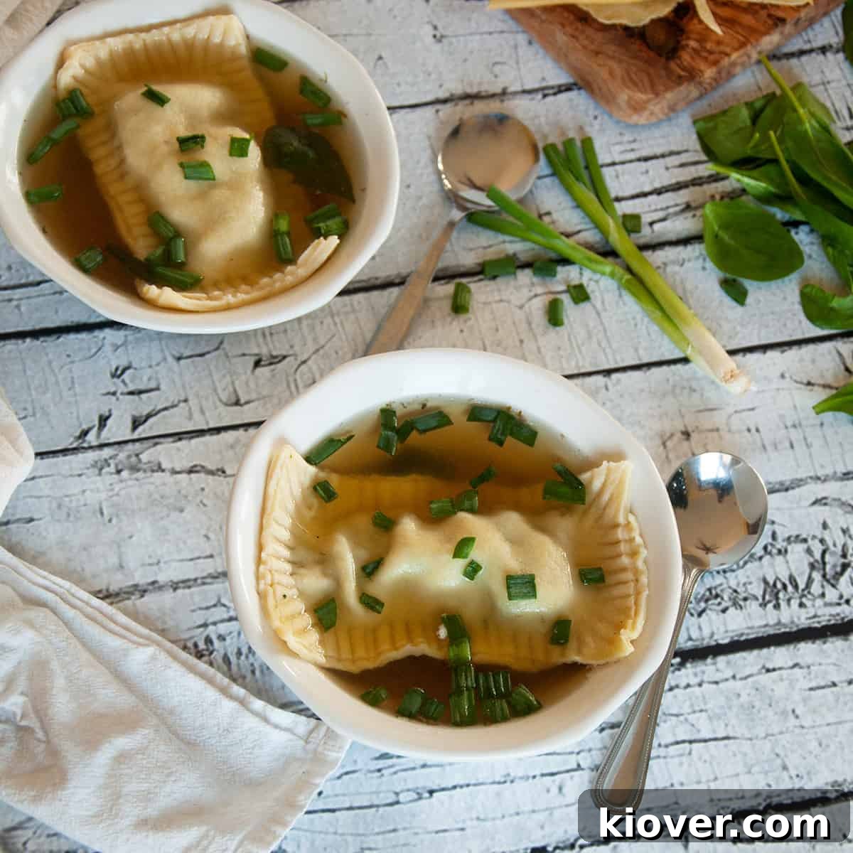 Two bowls of delicious Maultaschen soup, garnished and ready to serve.