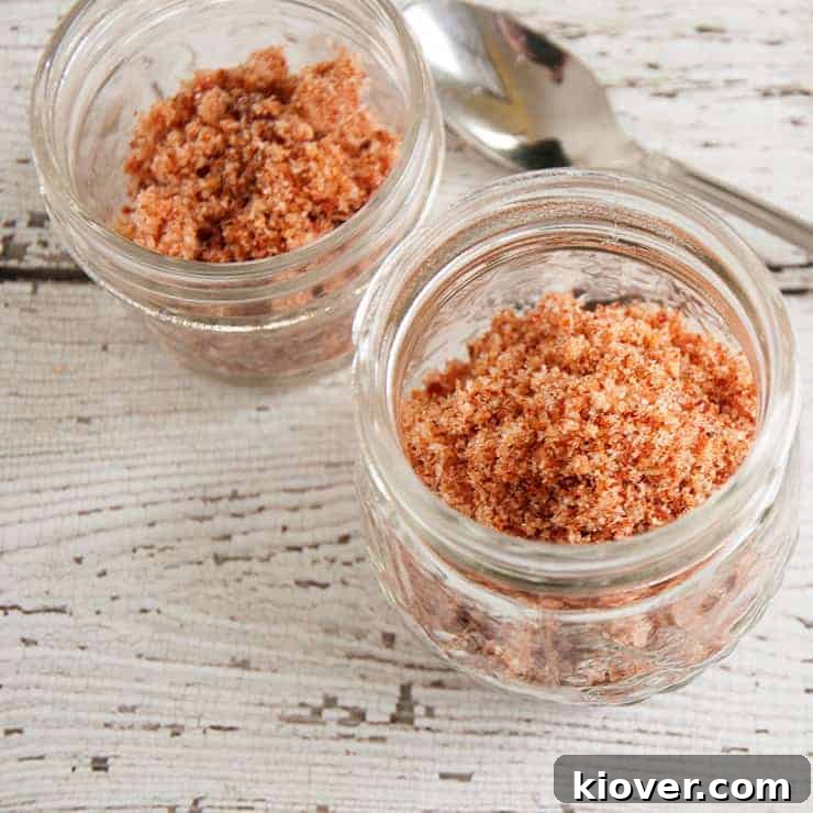 Two half-pint jars filled with homemade bacon salt, ready for storage or gifting.