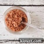 An overhead shot of bacon salt in a half pint jar