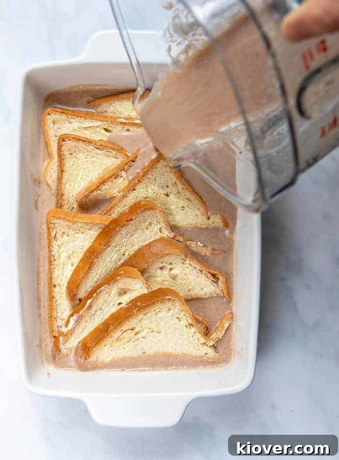 Pouring the creamy banana mixture into a baking dish, preparing for the layers of buttered bread