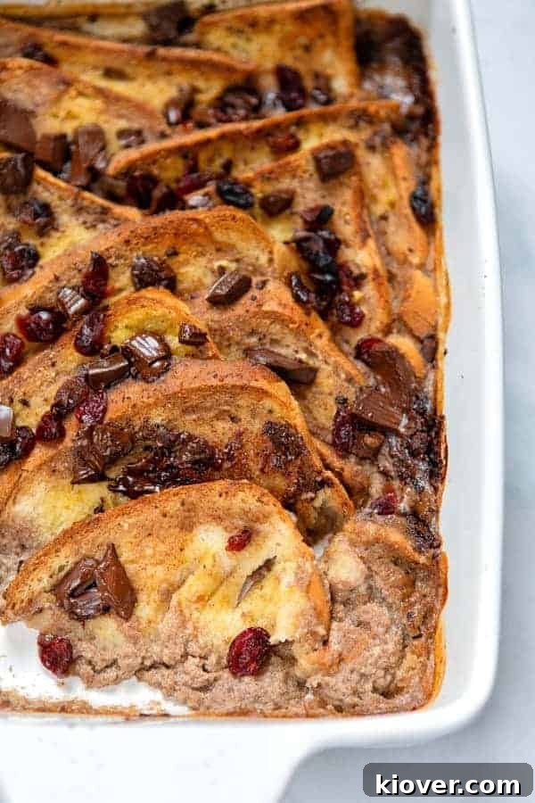 Front view of a generous slice of the decadent Banana Bread & Butter Pudding, showing its moist interior and delicious toppings