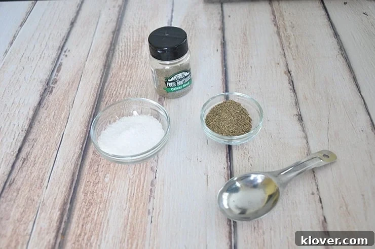 Celery Seed and Salt Ingredients A visual guide showing the simple ingredients for homemade celery salt: whole celery seeds and a bowl of salt, arranged neatly before grinding.