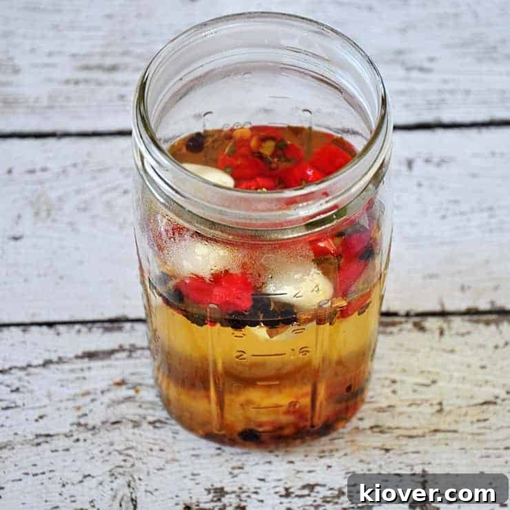 Pickling ingredients The pickling liquid and spices are prepared in the jar, awaiting the eggs
