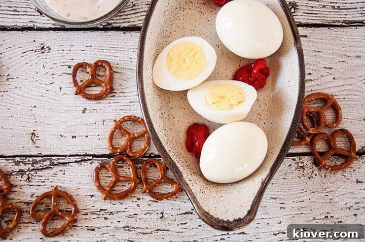 Overhead Pickled Spicy Eggs Overhead shot of a platter of pickled eggs, surrounded by peppers, ranch, and pretzels for serving