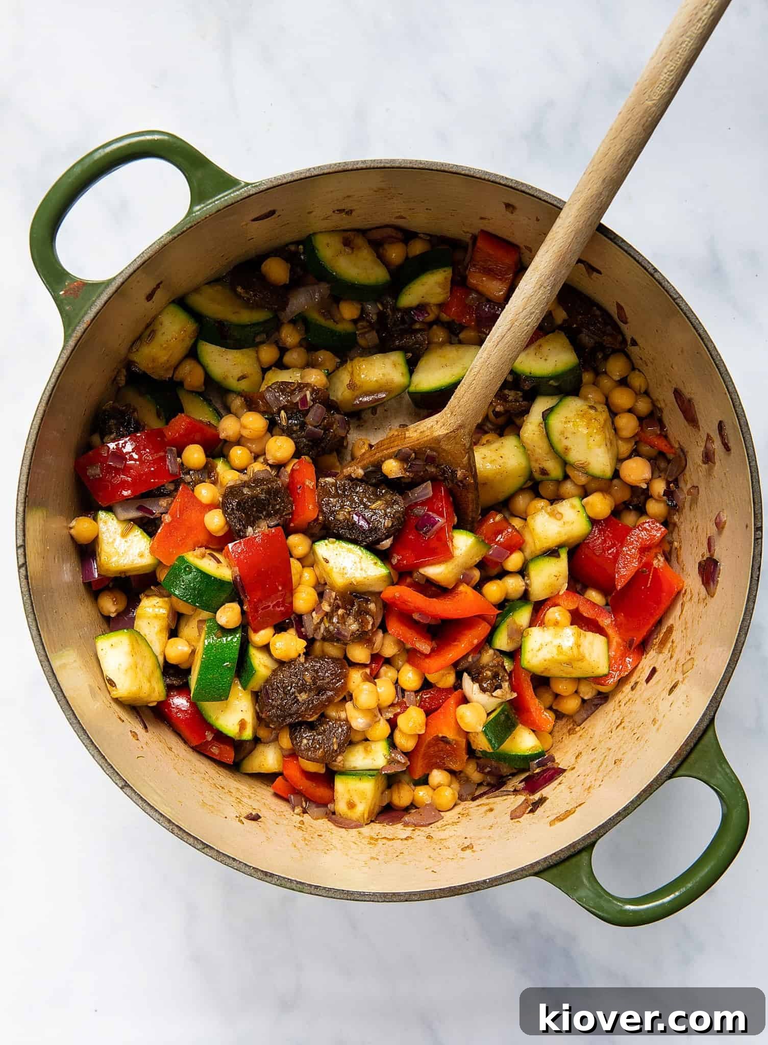 Sautéing vegetables and spices for tagine in a pot