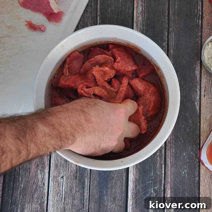 Mixing Beef Mixing beef in bowl.