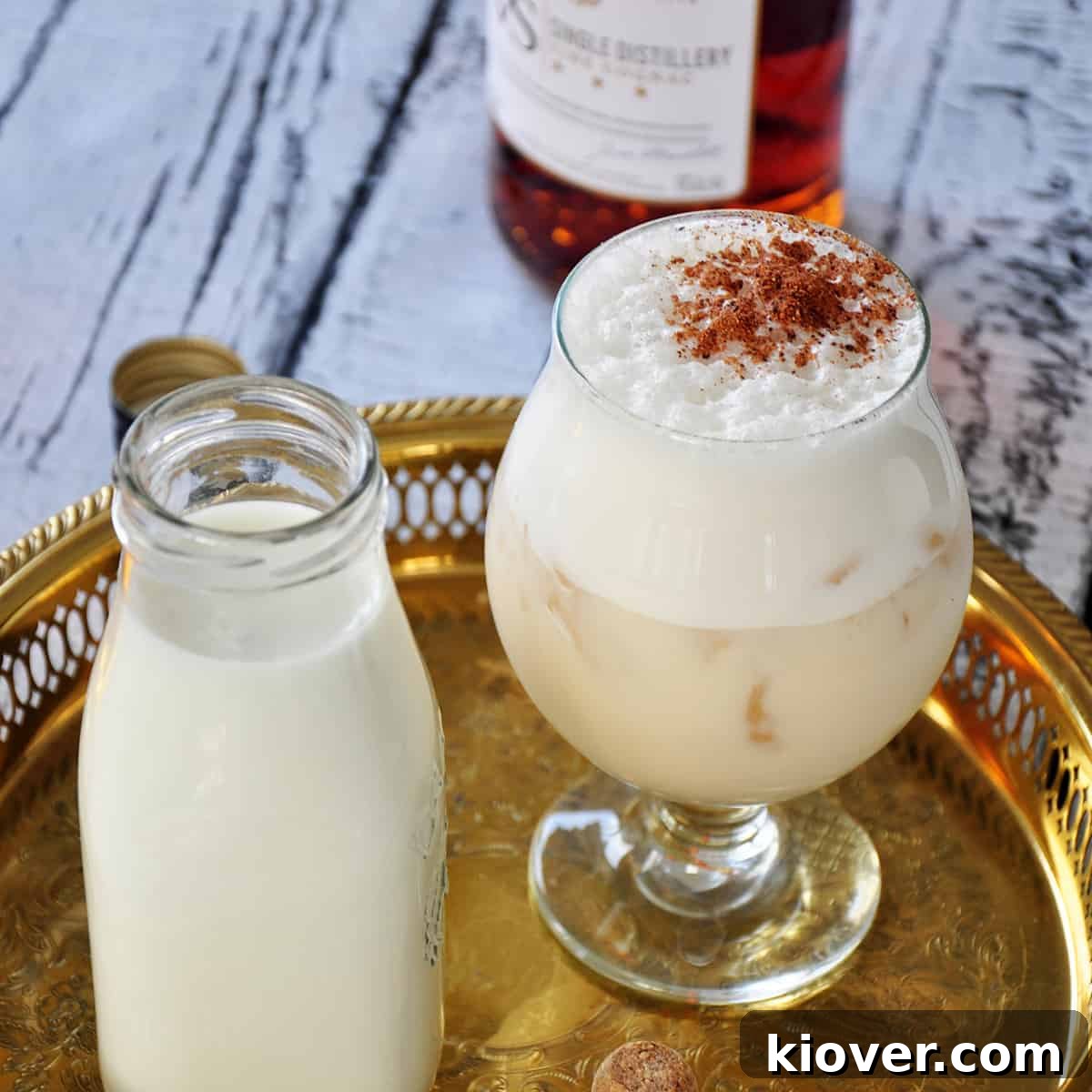 Glass of Milk Punch cocktail, garnished with grated nutmeg