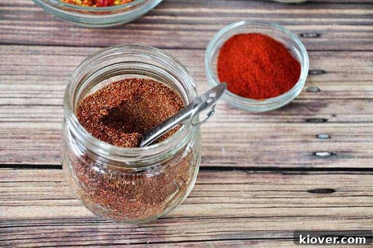 Side Taco Seasoning Bowl of homemade taco seasoning with a scoop in it, ready to be used, showcasing the fine texture and rich color.