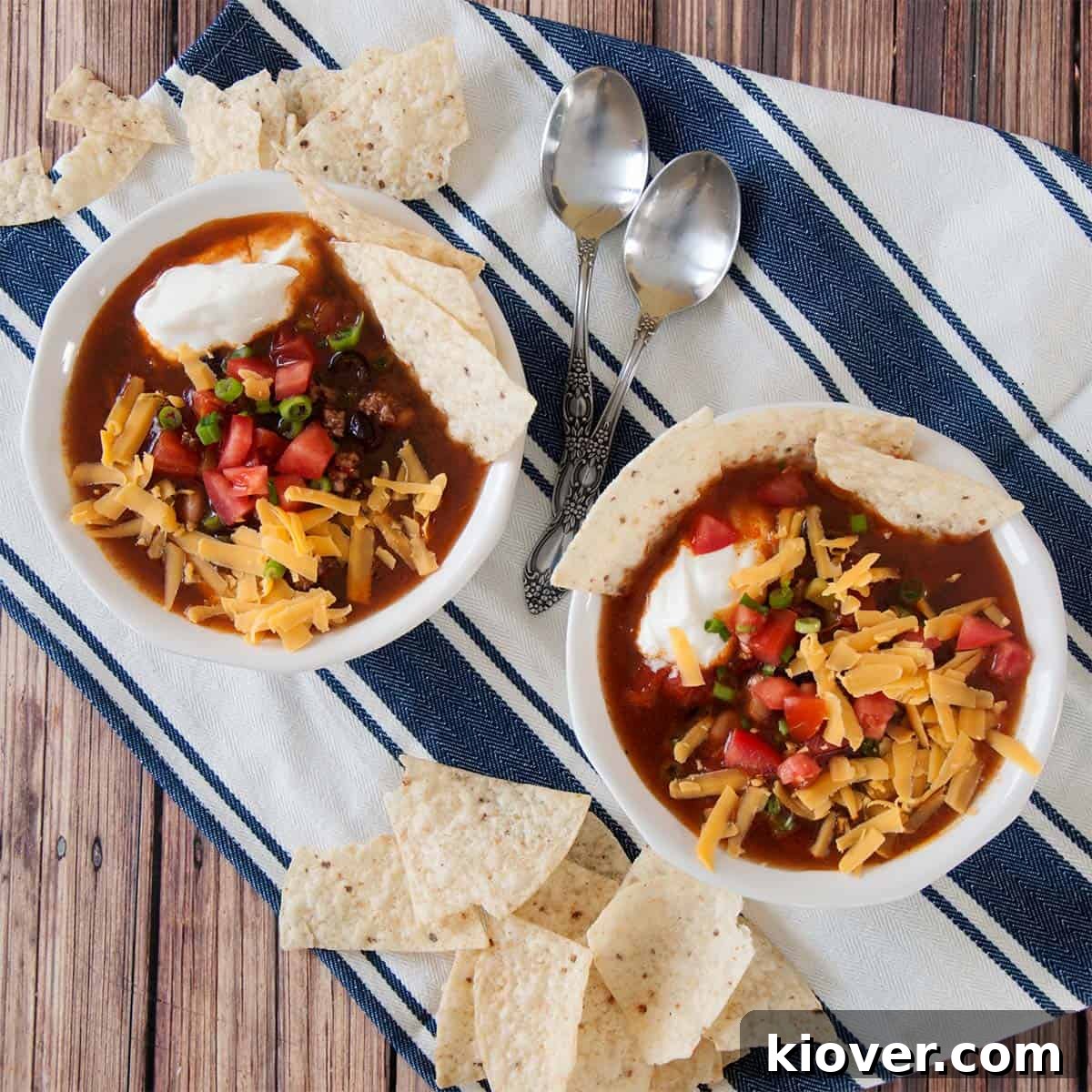 Effortless One-Pot Taco Soup 2 Overhead picture of two bowls of our easy taco soup on a blue and white napkin. Delicious and quick homemade taco soup ready to be served.
