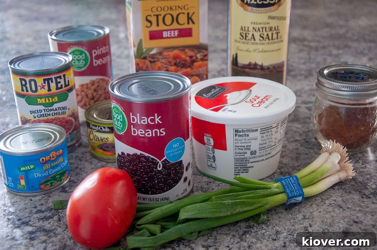 Effortless One-Pot Taco Soup 3 A picture of all the ingredients listed in the recipe below including ground beef, taco seasoning, beef stock, Rotel, black beans, pinto beans, black olives, green chilis, and extra toppings.