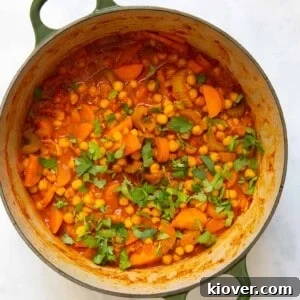 Chickpea stew in a large pot displayed on white background