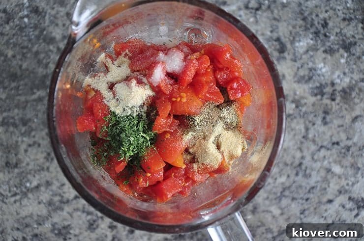 A collection of fresh, vibrant sauce ingredients, including canned diced tomatoes, herbs, and spices, before being blended for the pizza sauce.