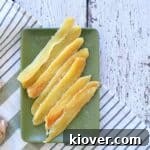 Dried Candied Ginger on a green plate and on a white table