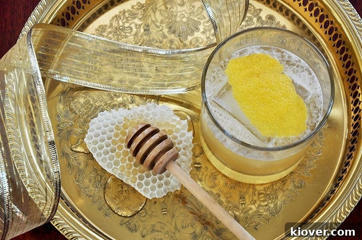Overhead picture of a Gold Rush Cocktail on a gold platter with some honey comb