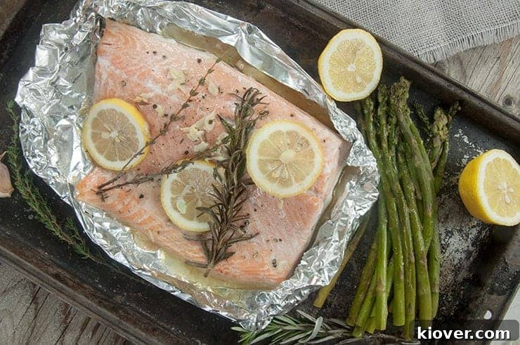 Diagonal view of tinfoil Grilled Salmon on a baking sheet.