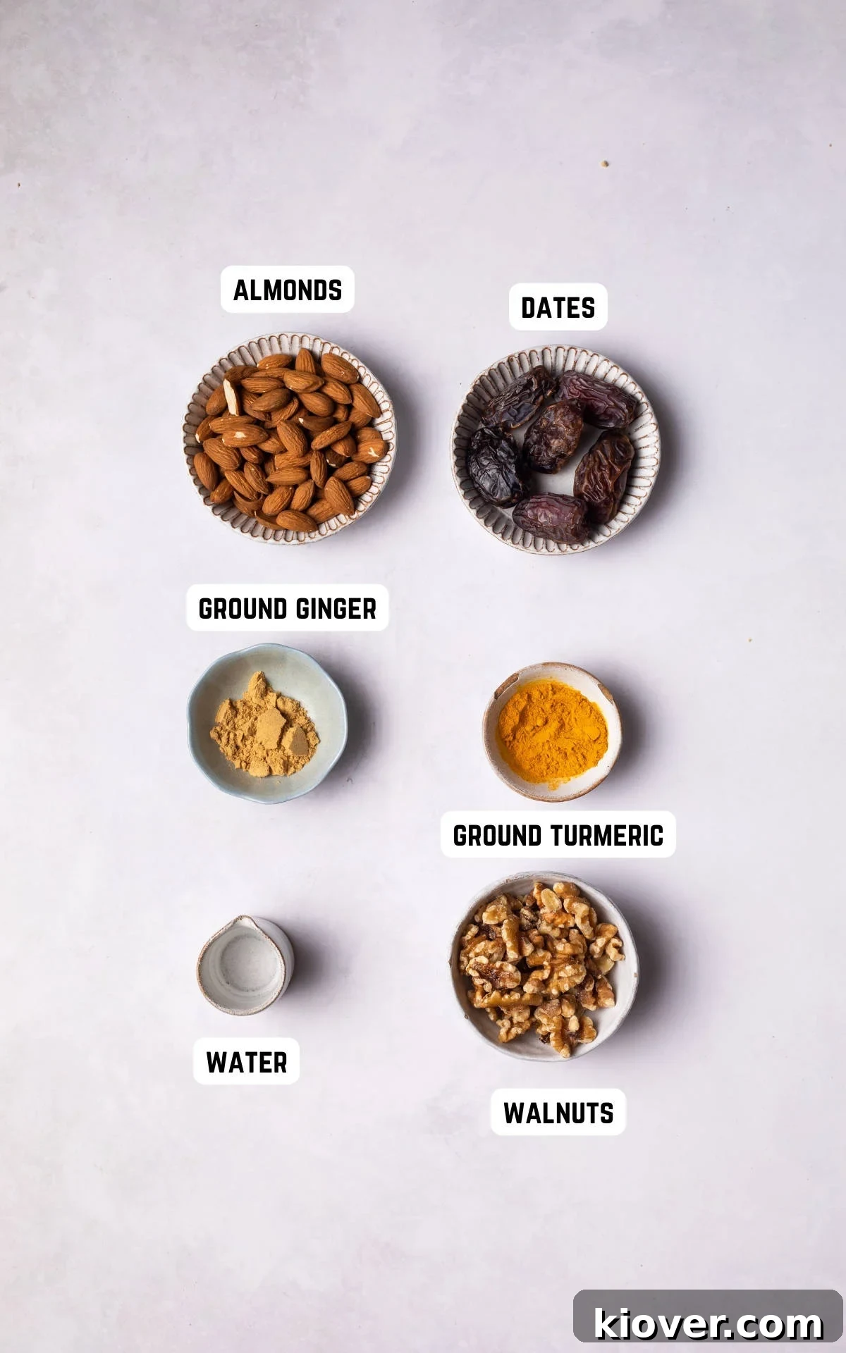 Fuel Bites 3 A selection of healthy energy ball ingredients laid out, including almonds, walnuts, dates, ground ginger, and ground turmeric.