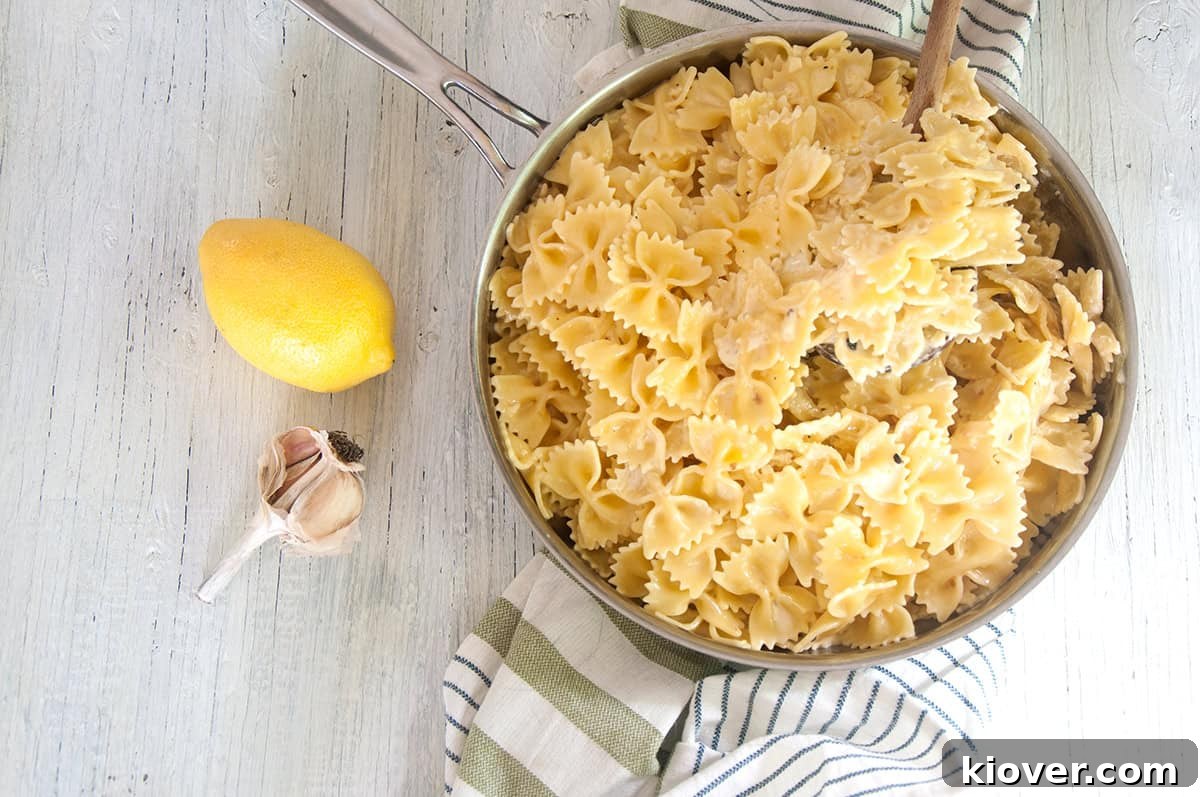 An overhead shot showcasing the Creamy Lemon Butter Sauce tossed with Farfalle pasta directly in the skillet, ready to be served.