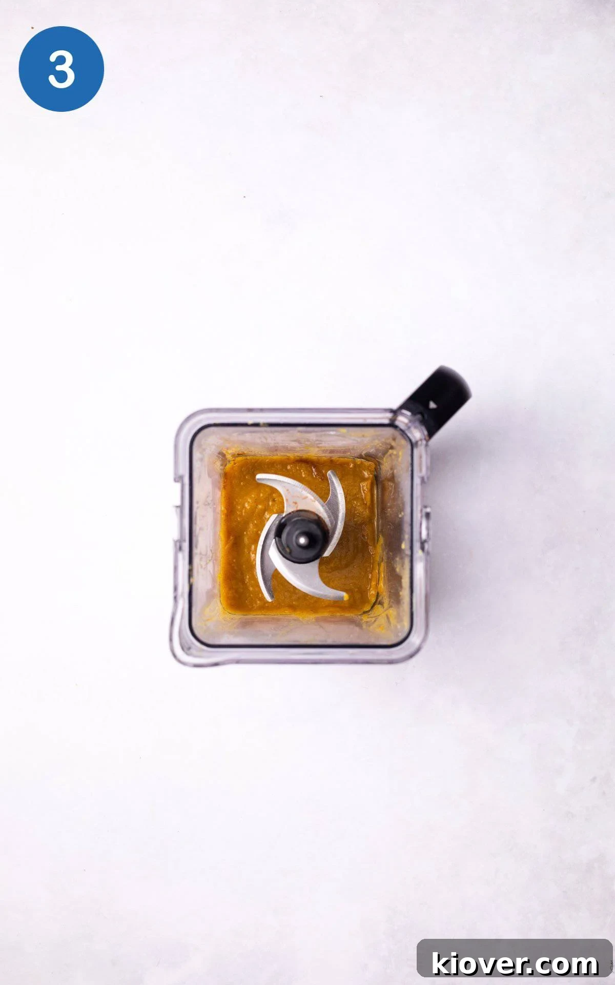 Golden Pumpkin Oat Bliss 6 Cooked pumpkin, maple syrup, and cinnamon being blended together in a food processor to create a smooth puree.