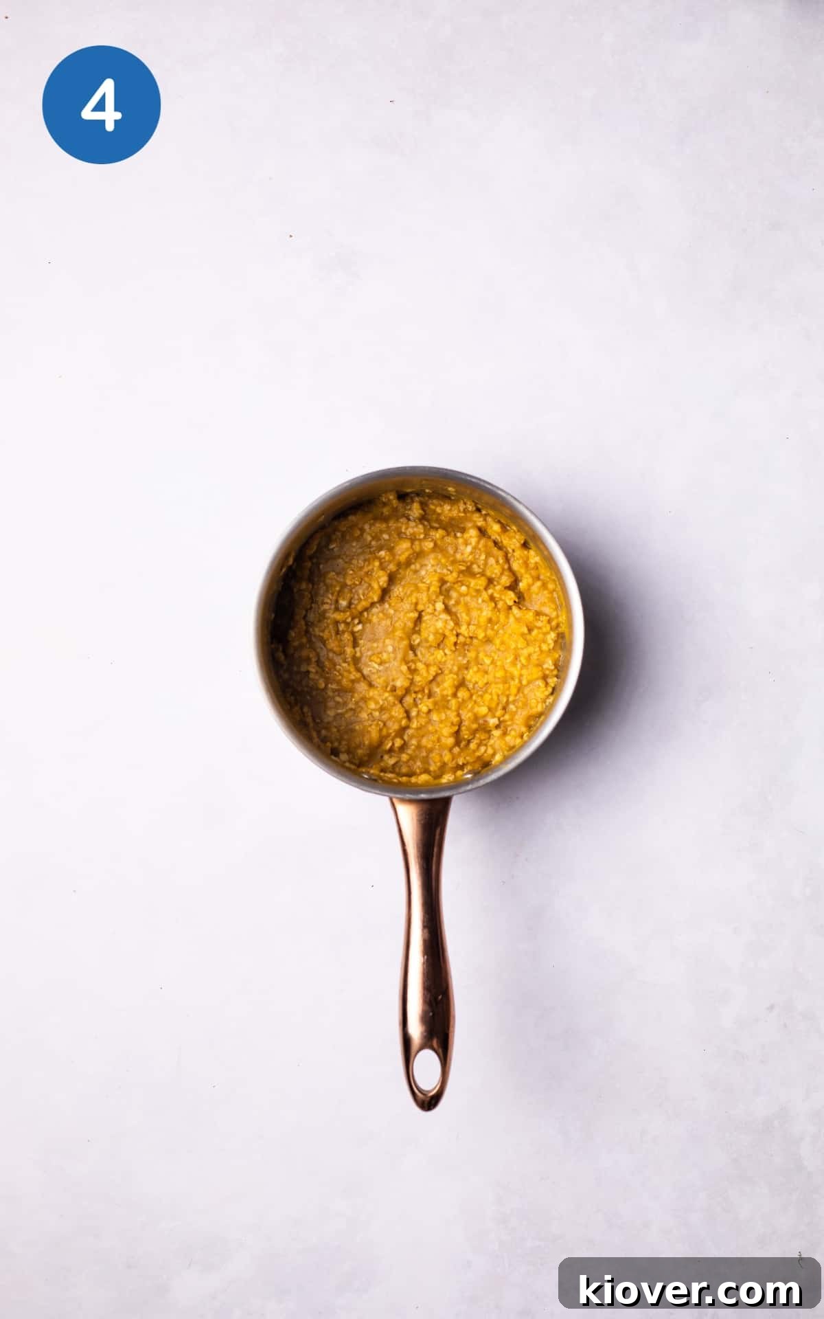 Golden Pumpkin Oat Bliss 7 A pot on the stove filled with pumpkin oatmeal, gently simmering to the desired consistency.