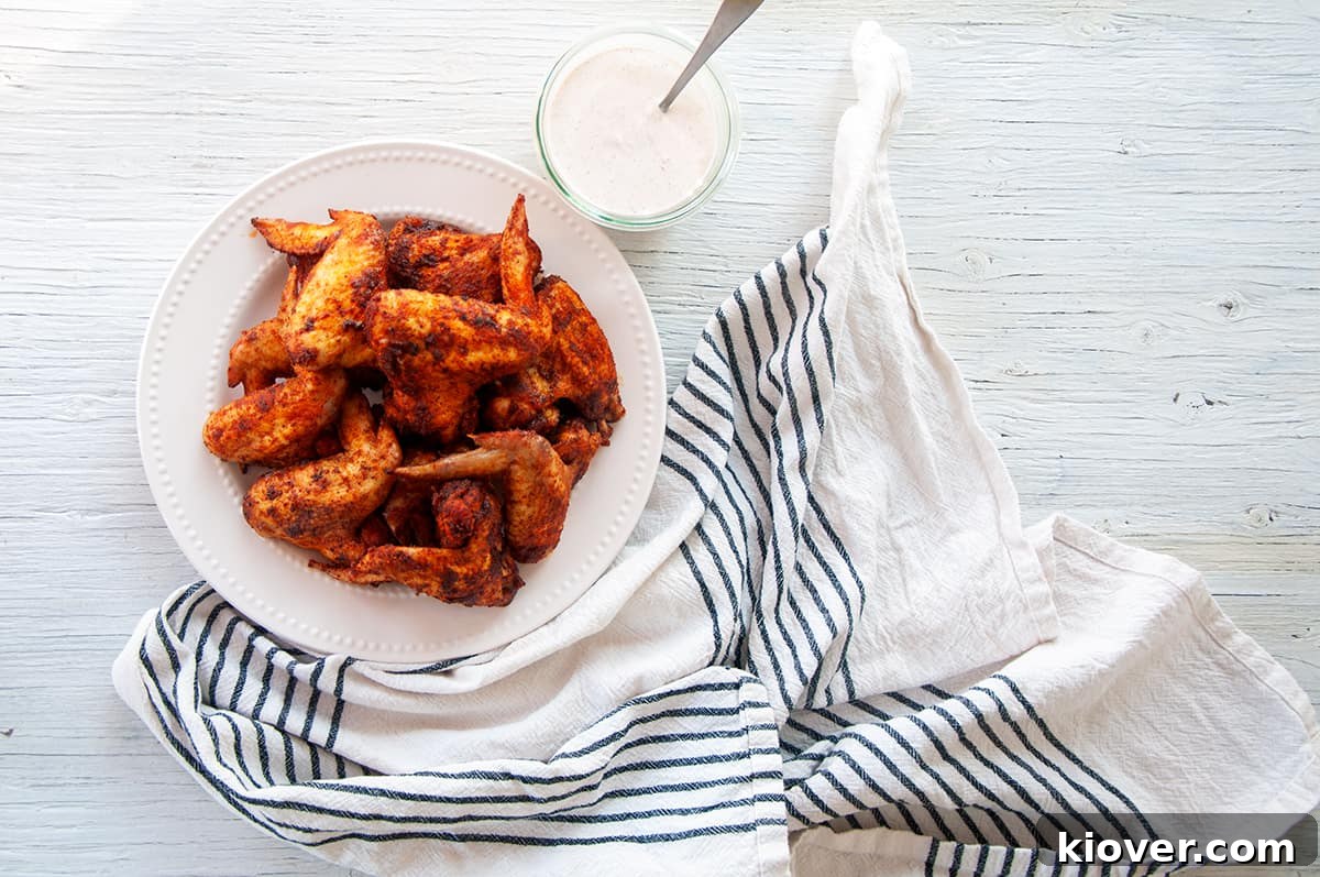 Plate of dry rub chicken wings and some dipping sauce.