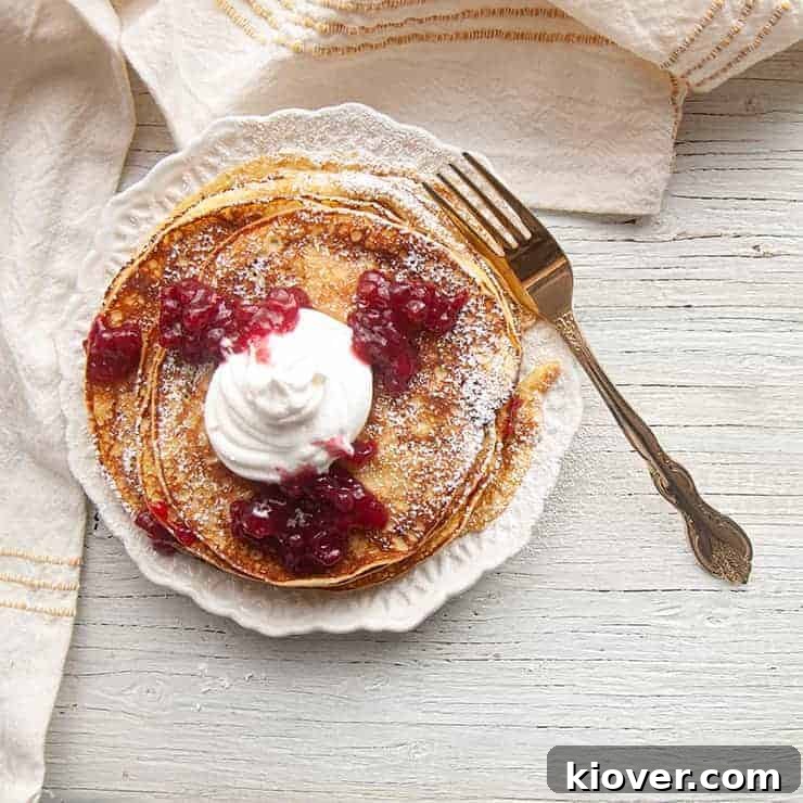 Top view of Swedish Pancakes with Lingonberry jam and Whipped cream.
