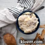 Make Ahead Sous Vide Mashed Potato in a blue bowl and mushroom gravy.