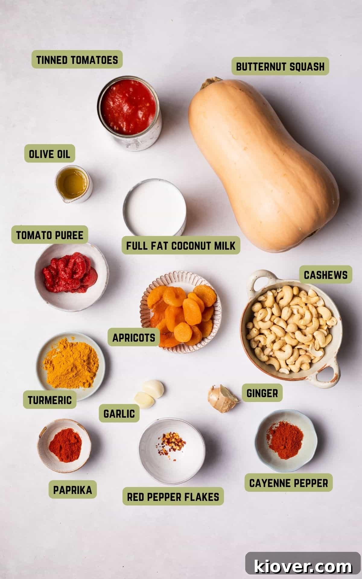 Golden Butternut Curry 3 Arrangement of fresh butternut squash curry ingredients including whole squash, garlic, ginger, spices, and canned goods.