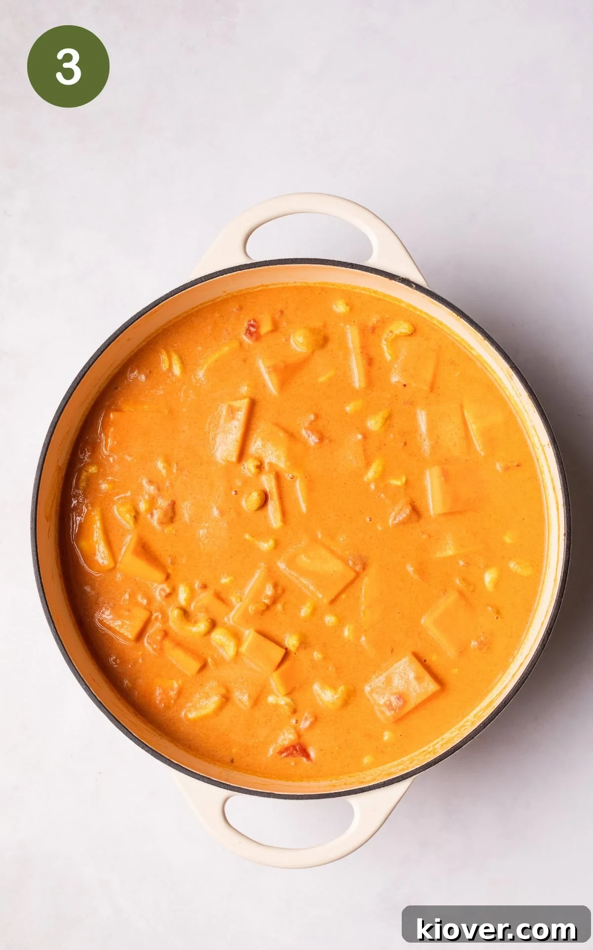 Golden Butternut Curry 6 Adding creamy coconut milk and cubed butternut squash to the pot, ready for simmering.