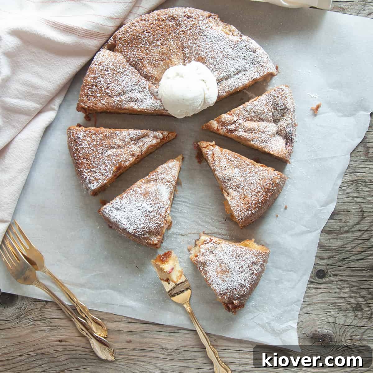 Rhubarb Cake Norwegian Rhubarb Cake cut into eight pieces on white parchment paper, ready to be served.